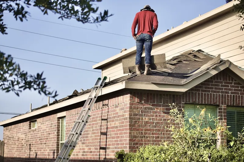 Professional roofer working on a residential roof in Tatamy